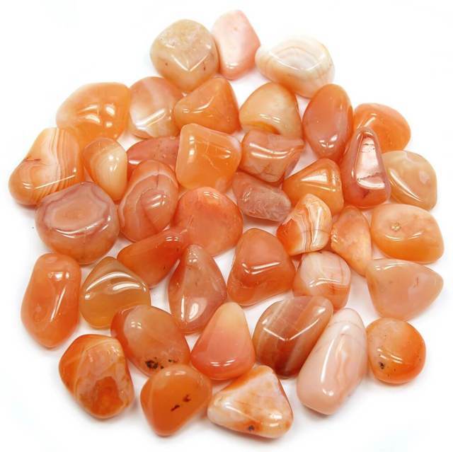 many pieces of tiny orange smooth stones top view